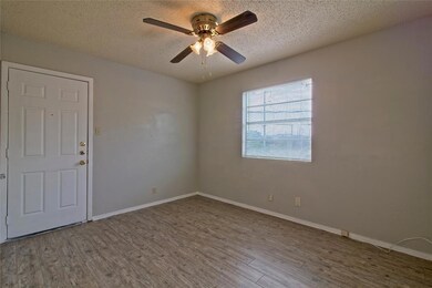 Spare room with a textured ceiling, wood finished