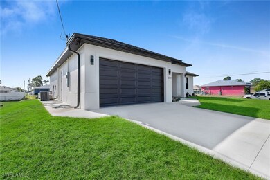 Garage with central AC unit and a yard