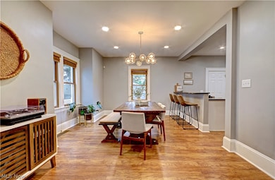Dining space featuring light hardwood / wood-style floors and an inviting chandelier