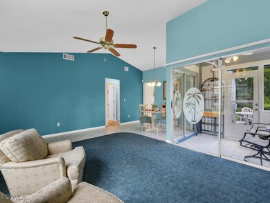 Tiled living room featuring a chandelier, a ceilin