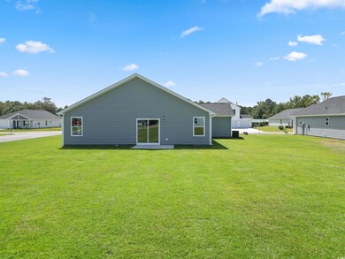 Back of house with a lawn