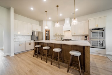 Extensive updates to the kitchen include custom white oak island, painted kitchen cabinets, new cabinet hardware, custom vent hood, new backsplash, new pendant​​‌​​​​‌​​‌‌​​​‌​‌​​​‌‌​​​‌‌​​​​​​‌‌​‌‌‌ lights.