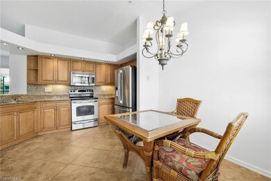 Kitchen with an inviting chandelier, backsplash, granite countertops, stainless steel kitchen appliances, and custom lighting