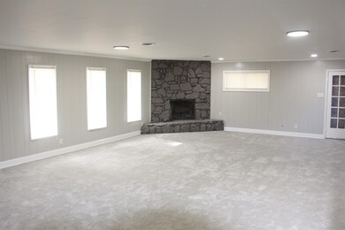 Unfurnished living room with a fireplace, carpet, 