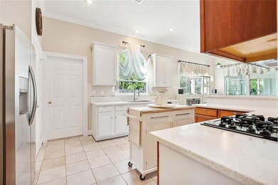 Kitchen with double ovens, gas cooktop & stone cou