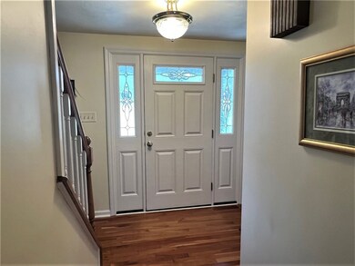 FRONT DOOR WITH SIDE LITES AND LOVELY HARDWOOD ENT