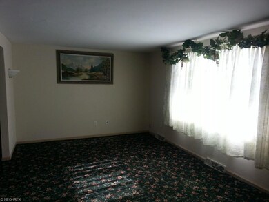 Large Living room area, wall to wall carpet, pictu