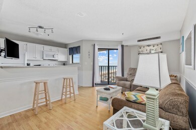 Living area featuring visible vents, baseboards, a textured ceiling, and light wood-style flooring