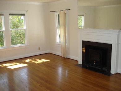 Large living area w/refinished hardwoods, gas fire