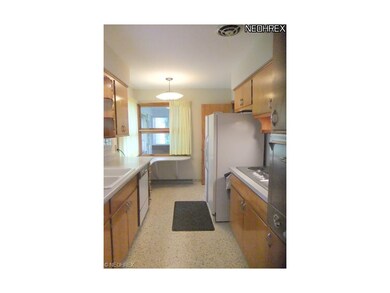 Galley style kitchen features built-in table, birc