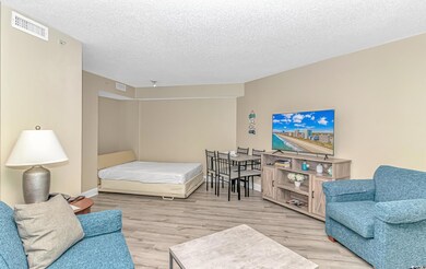 Bedroom with a textured ceiling and light wood-type flooring