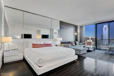 Bedroom with floor to ceiling windows and wood fin