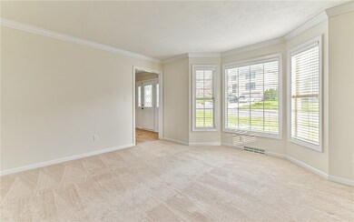 SPACIOUS LIVING ROOM w/ new paint, Crowne Moulding, beautiful front-facing Bay Windows.