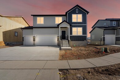View of front facade featuring board and batten siding, concrete driveway, and an attached garage