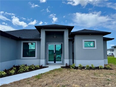 Back of house with stucco siding, a shingled roof,
