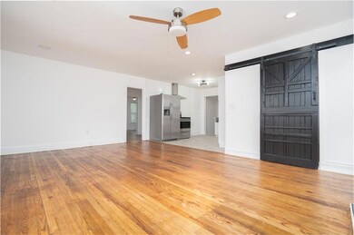 Unfurnished living room featuring ceiling fan, lig