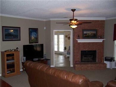 Nice den with two sided fireplace. Other side open