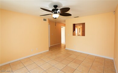 Empty room featuring light tile patterned floors,