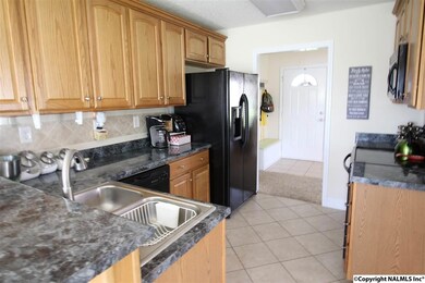 THE KITCHEN OFFERS A TILE BACKSPLASH AND A PANTRY!