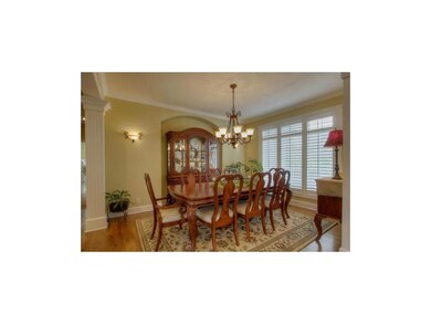 Formal dining room with plantation shutters and ha