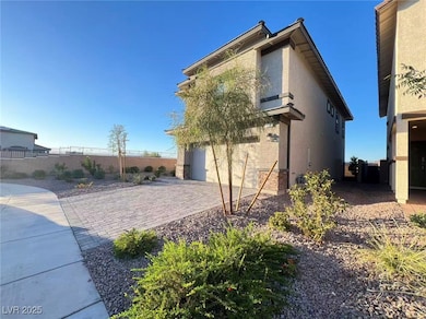 View of side of home with stucco siding, driveway, and an attached garage