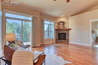 Living room featuring a fireplace, light wood-type