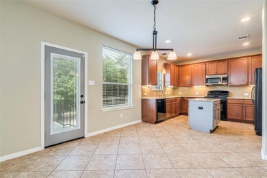 Kitchen featuring black appliances, tasteful back