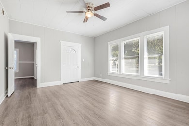 Unfurnished room with ceiling fan and hardwood / w
