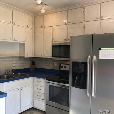 Kitchen with white cabinets, stainless steel appli