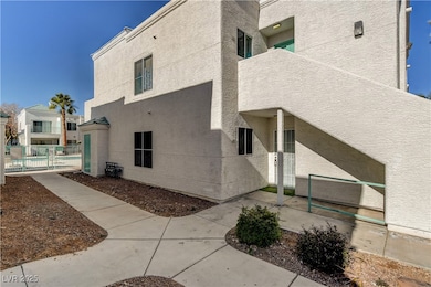 View of home's exterior with stucco siding and a p