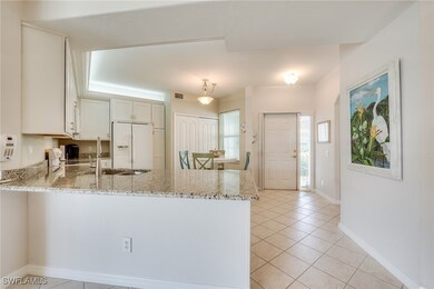 Kitchen featuring white fridge with ice dispenser,