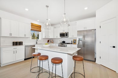 (Photo of an inventory home, actual homes finishes will vary) This spacious kitchen features a large pantry, quartz countertops, LVP floors, stainless appliances and more!