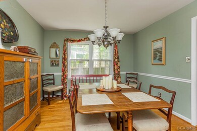Beautiful hardwood floors and chair rail in dining  room.
