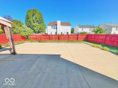 large patio area with a fully fenced backyard