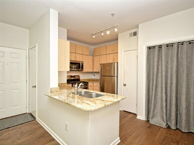 Kitchen featuring dark wood-type flooring, applia