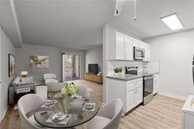 Kitchen with white cabinets, open floor plan, and 