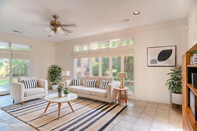 Light-Filled 21x15 Bonus/Sunroom Featuring a Tile Floor, 9 Ft Smooth Ceiling, Plantation Shutters, and Walls of Windows Overlooking the Private Rear Grounds.