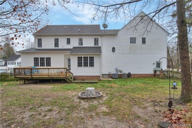 Back of property featuring a lawn, central AC unit