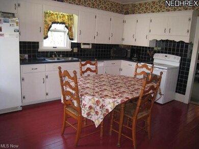 Large eat-in kitchen with hardwood floors.