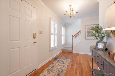 Entrance foyer with baseboards, stairway, crown mo