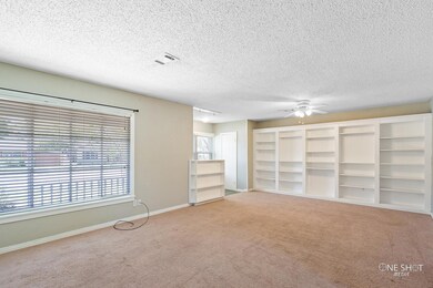 Unfurnished living room featuring a textured ceili