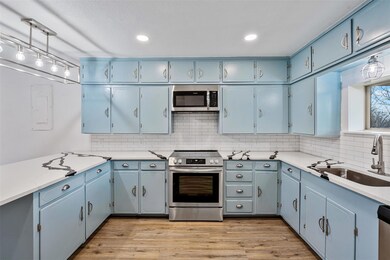 Kitchen with pendant lighting, sink, decorative ba