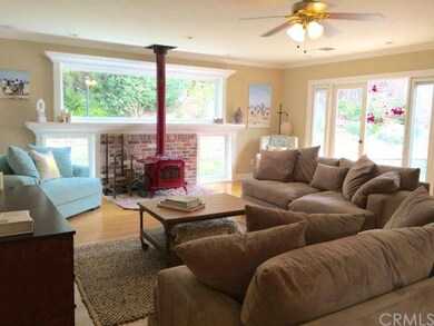 Living room has fireplace, large picture windows a