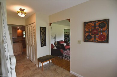 Foyer with view of living room and kitchen.