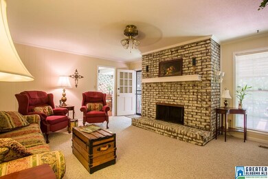 FAMILY ROOM WITH FIREPLACE OPENS ONTO A DECK TO EX