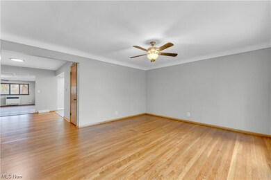 Empty room with light hardwood / wood-style flooring, ceiling fan, and a wall mounted AC