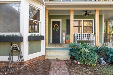 Entrance to property with covered porch and a ceiling fan