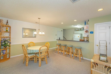 Dining area with baseboards, a textured ceiling, a