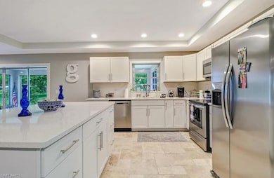 Kitchen with stainless steel appliances, white cab