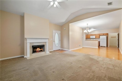 Unfurnished living room with a tile fireplace, lig